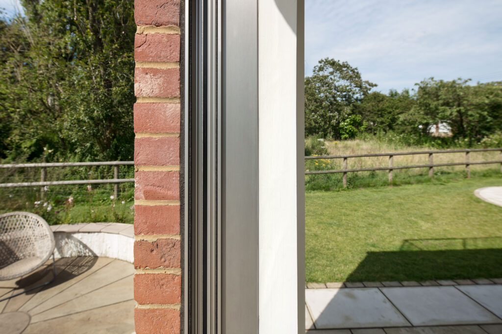 Exposed brickwork installation of minima sliding doors in Kent