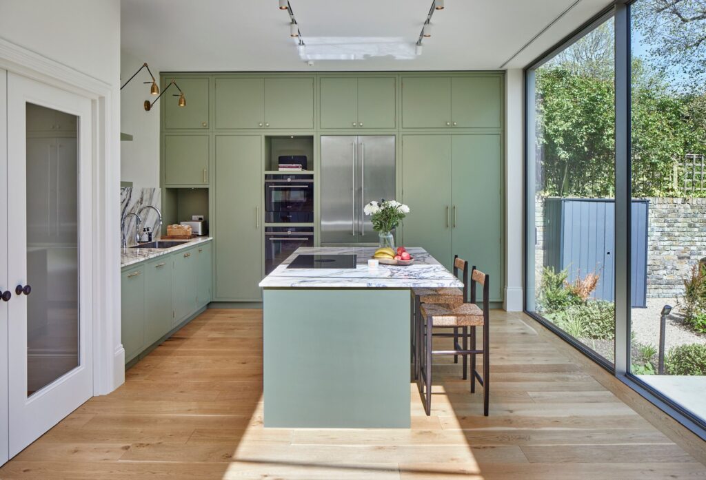 silver sliding doors with no frames installed brick built extension in London